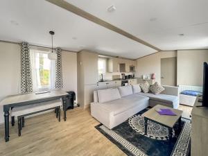 a living room with a couch and a table at Rosie's Retreat in Morpeth
