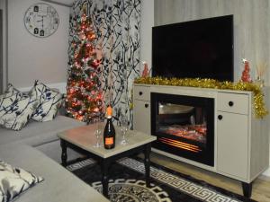 a living room with a christmas tree and a fireplace at Rosie's Retreat in Morpeth