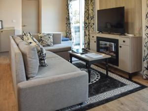 a living room with a couch and a fireplace at Rosie's Retreat in Morpeth +17 photos