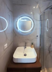 a bathroom with a white sink and a mirror at VOULGARIS in Agios Georgios