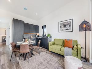 a living room with a green couch and a table at Lodge Six - Uk42798 in Llangefni