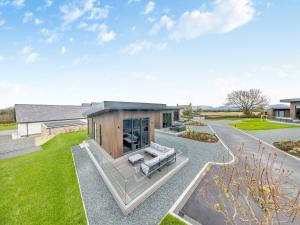 a house with a living room and a patio at Lodge Six - Uk42798 in Llangefni +5 photos
