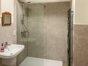 a bathroom with a shower and a sink at Brewhouse - Uk48743 in Llandybie
