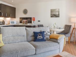 a living room with a gray couch with a blue pillow at Waterside Retreat in Carnforth