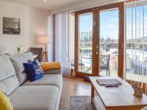 a living room with a couch and a table at Waterside Retreat in Carnforth