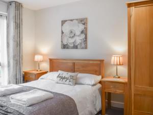 a bedroom with a bed with two night stands and two lamps at Waterside Retreat in Carnforth +10 photos