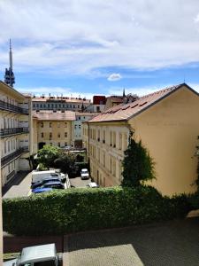 a view of a city with cars parked in a parking lot at Cozy Flat at Žižkov & Free Parking in Prague