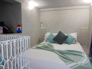a white bed with pillows on it in a bedroom at Studio Turquesa Kasbah Tangier in Tangier