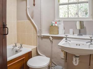 a bathroom with a toilet and a sink at Tarn Cottage in Grasmere +14 photos