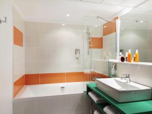 un baño con lavabo y bañera en ibis Styles Montpellier Centre Comedie, en Montpellier 34 fotos más