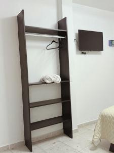 a closet with a tv in a room at Casa Monarca in Oaxaca City