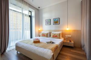a bedroom with a large bed and a large window at Apartment KeyGo #0066 comfort and coziness in the city in Yerevan