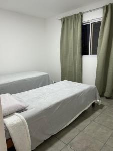 a bedroom with two beds and a window at Departamentos Casa Pueblo in Villa Mercedes