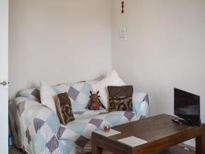 a living room with a couch with pillows and a table at Inverness Haven in Inverness