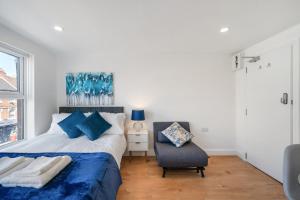 a bedroom with a bed and a chair and a window at Amazing Studio in Central London - 5 in London