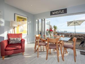 a dining room with a table and chairs and a sign that readscesterwrite at Seaspray, Coastguard Cottages in Dawlish