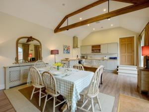 a kitchen and dining room with a table and chairs at The Stables At Weedon Hill Farm in Church Stowe