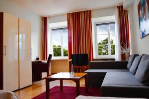 a living room with a couch and a table at Hotel Trierer Hof in Koblenz