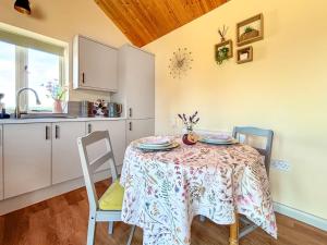 a kitchen with a table and chairs in a kitchen at Springhill Lodge in Kirk Ireton