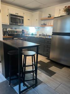 a kitchen with a black table and a refrigerator at Cottage by the cabin in Springfield