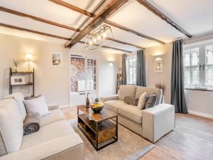a living room with a couch and a table at Forge House in Thornton Dale