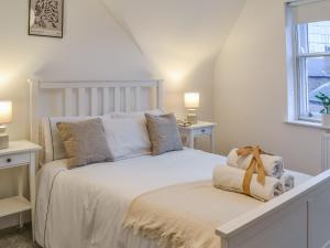 a bedroom with a white bed and a window at Roof Tops in York