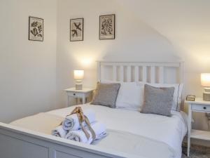 a bedroom with a white bed with two tables at Roof Tops in York +10 photos