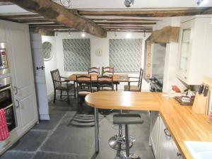 a kitchen with a table and chairs in a room at Garden Cottage in Threlkeld