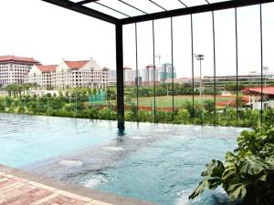 a swimming pool with a view of a city at RumaKU at Bell Suites KLIA - Studio - Wifi in Sepang