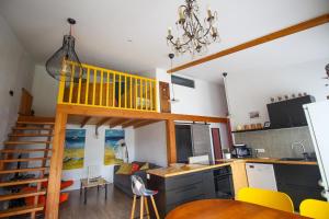 a kitchen and living room with a loft bed at AN GOVEL in Crozon