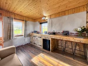 a kitchen with wooden floors and a counter top at Willow Bale Cabin - Uk49074 in Ballindalloch