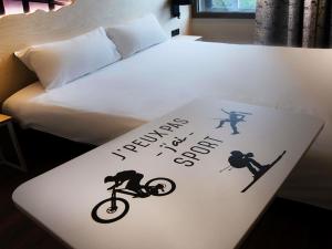 a bed with a sign that says tomorrow is a good day at ibis Styles Clermont-Ferrand Aéroport in Clermont-Ferrand +49 photos