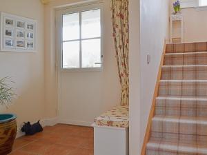 a staircase in a home with a window at Mill Cottage in Comrie +10 photos