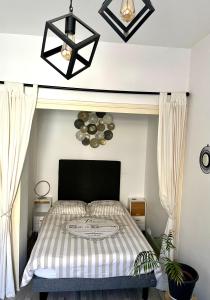 a bedroom with a bed with a black and white comforter at Chic & Elégance Lyon Centre in Lyon