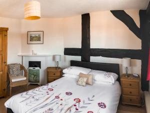 Un ou plusieurs lits dans un hébergement de l'établissement The Cottage
