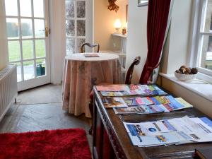 a room with a table with publications on it at White Rose Cottage in Robin Hood's Bay