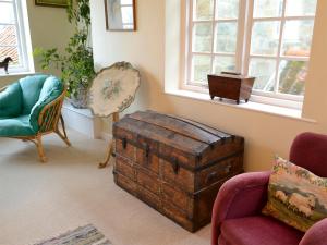a room with an old trunk and chairs and a window at White Rose Cottage in Robin Hood's Bay +4 photos