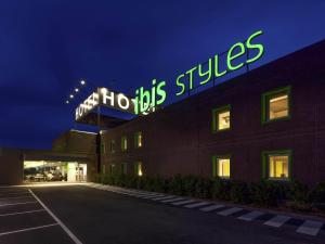 a building with a sign on top of it at night at Hotel Ibis Styles Lleida Torrefarrera in Lleida