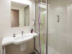 a bathroom with a sink and a shower at Hotel Ibis Styles Lleida Torrefarrera in Lleida