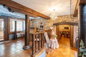 a large living room with a stone wall at Hôtel Berceau Du Vigneron in Turckheim