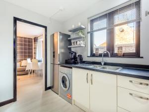 una cocina con fregadero y lavadora en Failte Luxury Apartment, en Inverness 12 fotos más