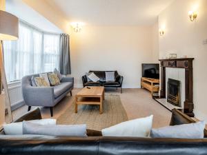a living room with a couch and a fireplace at Innishkea in Tenby