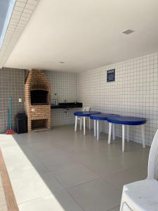 a room with two blue tables in a kitchen at Flat Costa Nova VIP - em Ponta Verde - Apartamento 202 - 1 Quarto - Proximo a Praia in Maceió