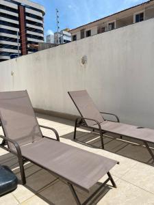 three chairs sitting on top of a roof at Flat Costa Nova VIP - em Ponta Verde - Apartamento 202 - 1 Quarto - Proximo a Praia in Maceió