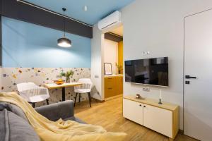 a living room with a couch and a tv and a table at Apartment KeyGo #0067 near Yerevan Fortress in Yerevan +13 photos