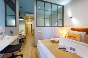a hotel room with a bed and a desk and a chair at Apartment KeyGo #0067 near Yerevan Fortress in Yerevan