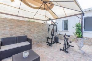 a gym with two exercise bikes and a tent at Jungle Holiday Villa in Marina dʼAvola