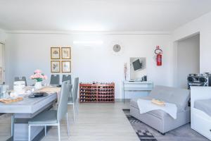 a living room with a table and a dining room at Jungle Holiday Villa in Marina dʼAvola