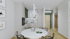 ein weißes Esszimmer mit einem weißen Tisch und Stühlen in der Unterkunft Apartament Margaret in Oppeln + 9 Fotos
