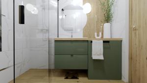 ein Badezimmer mit einem grünen Waschtisch und einer Dusche in der Unterkunft Apartament Margaret in Oppeln